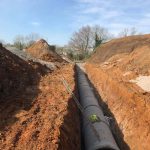 Installing concrete drain pipes